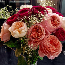 Baby's Breath arranged within a red and pink bouquet
